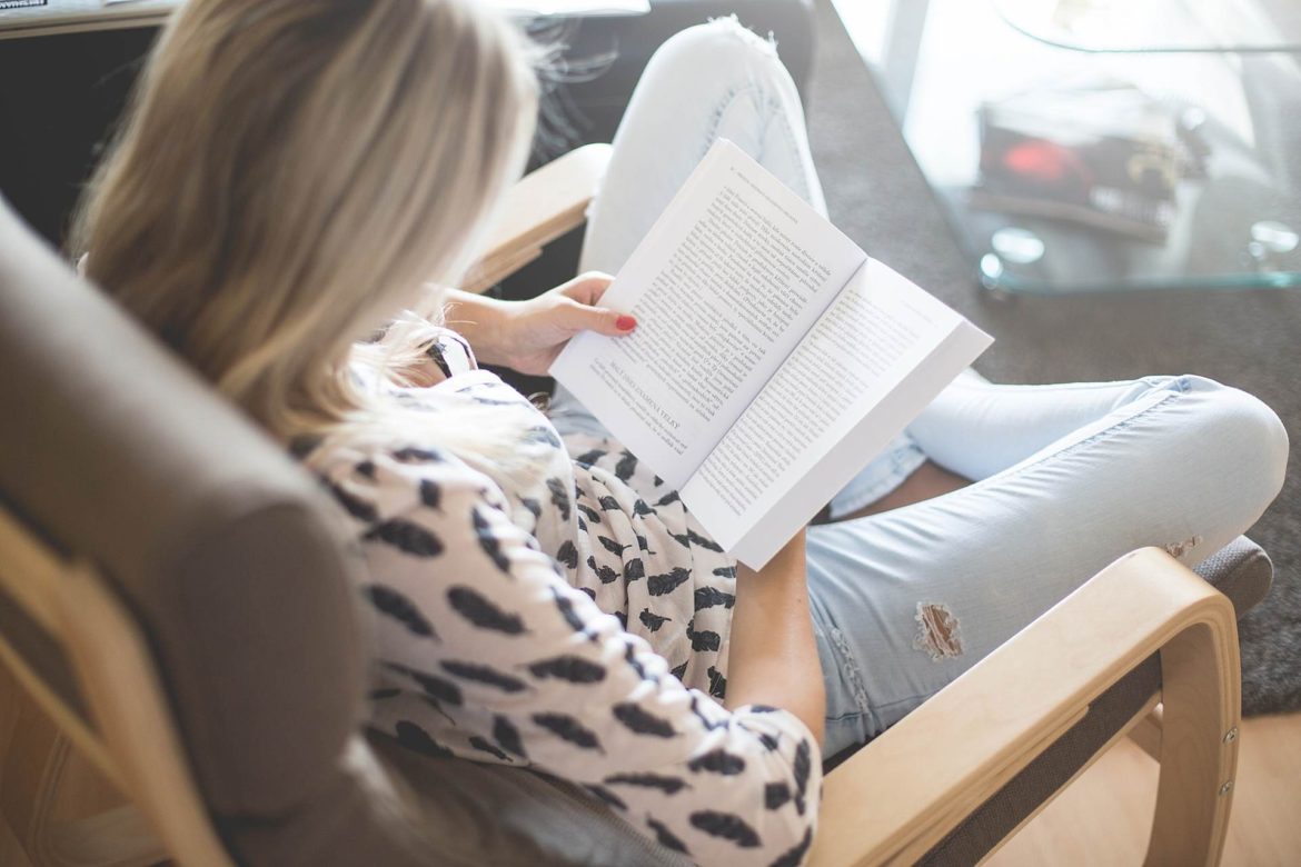 Woman Reading a Book in a Chair